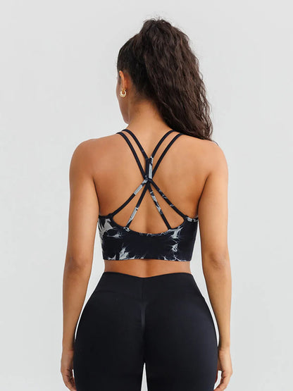 A model wearing a BRXL® B R X L™ Seamless Criss Cross Spaghetti Racerback Sports Bra