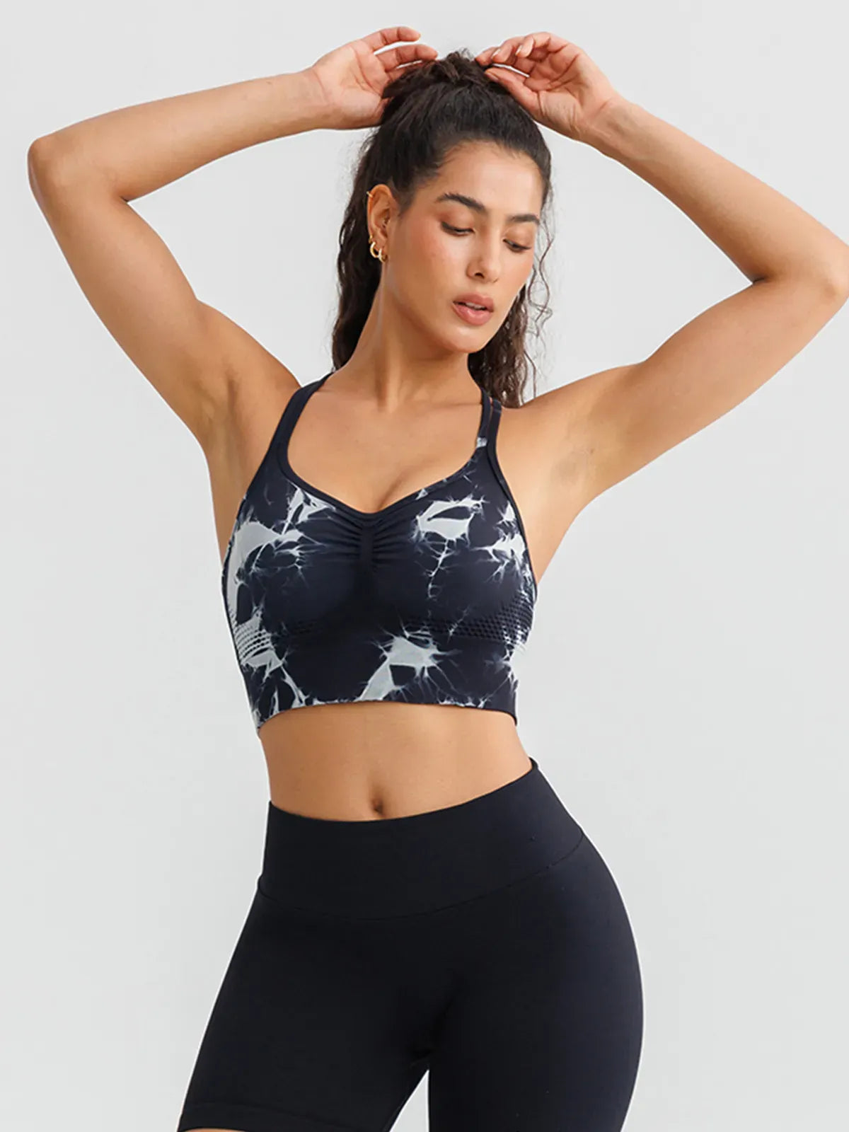 A model wearing a BRXL® B R X L™ Seamless Criss Cross Spaghetti Racerback Sports Bra