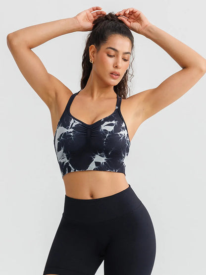 A model wearing a BRXL® B R X L™ Seamless Criss Cross Spaghetti Racerback Sports Bra