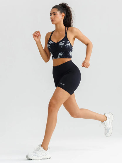 A model wearing a BRXL® B R X L™ Seamless Criss Cross Spaghetti Racerback Sports Bra