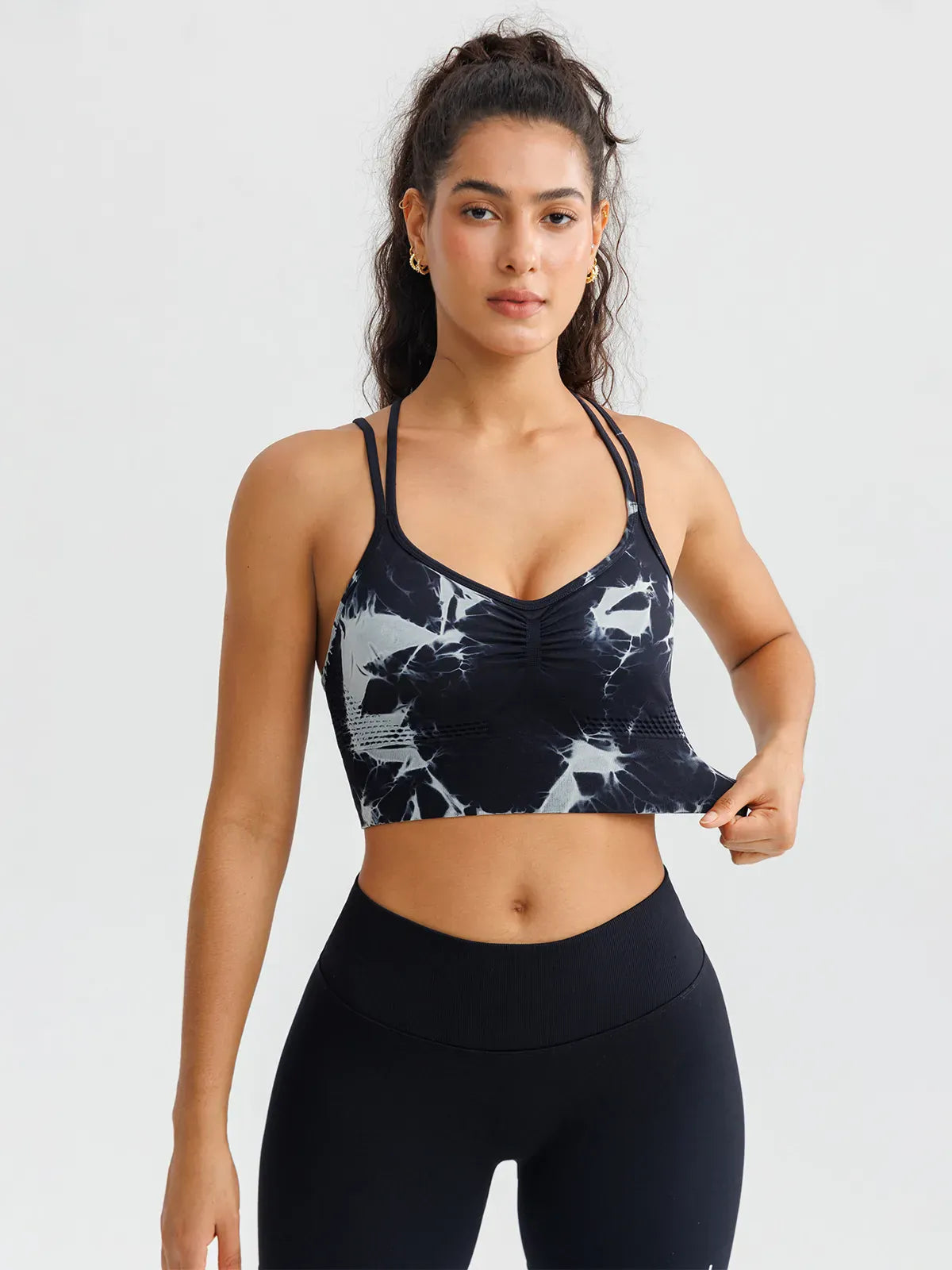 A model wearing a BRXL® B R X L™ Seamless Criss Cross Spaghetti Racerback Sports Bra