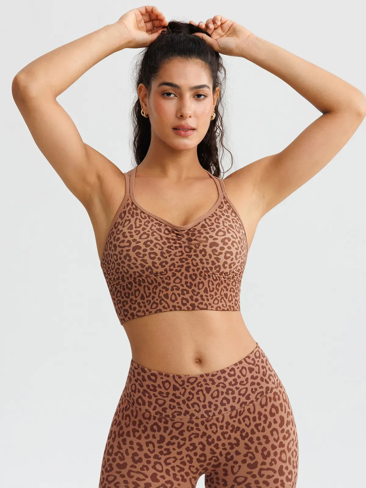 A model wearing a BRXL® B R X L™ Seamless Criss Cross Spaghetti Racerback Sports Bra