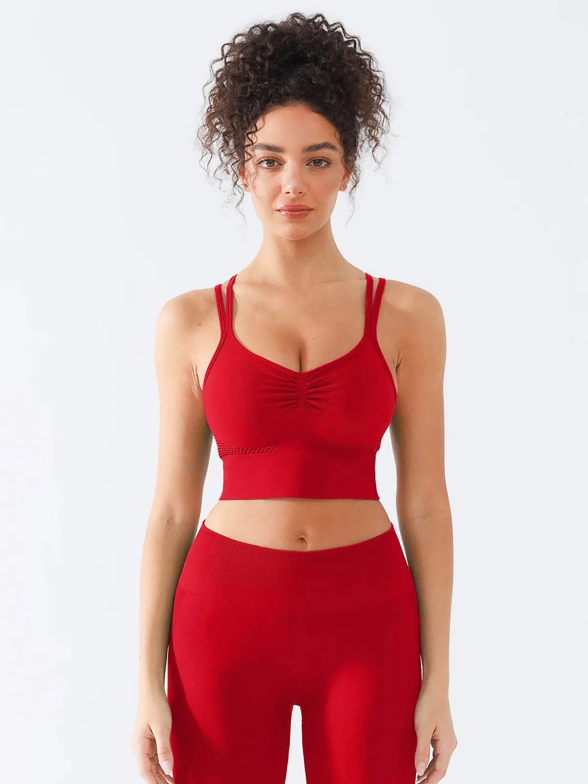 A model wearing a BRXL® Seamless Criss Cross Spaghetti Racerback Sports Bra