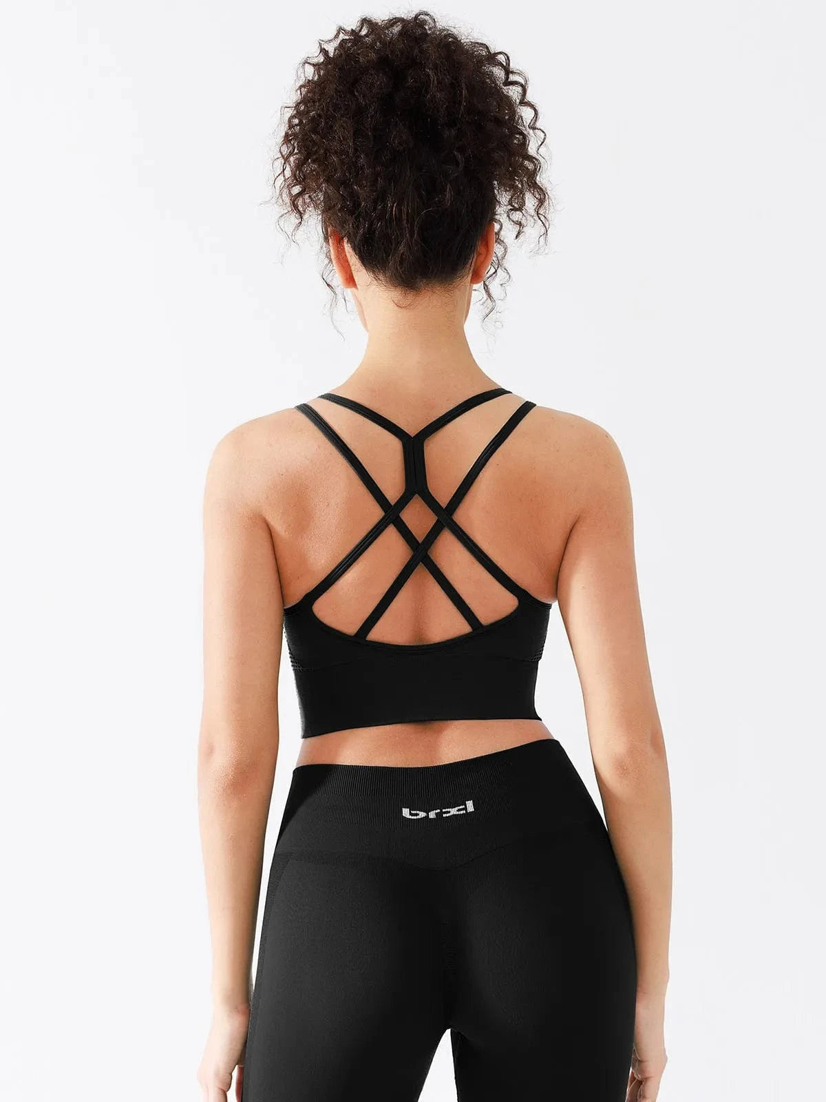 A model wearing a BRXL® Seamless Criss Cross Spaghetti Racerback Sports Bra in