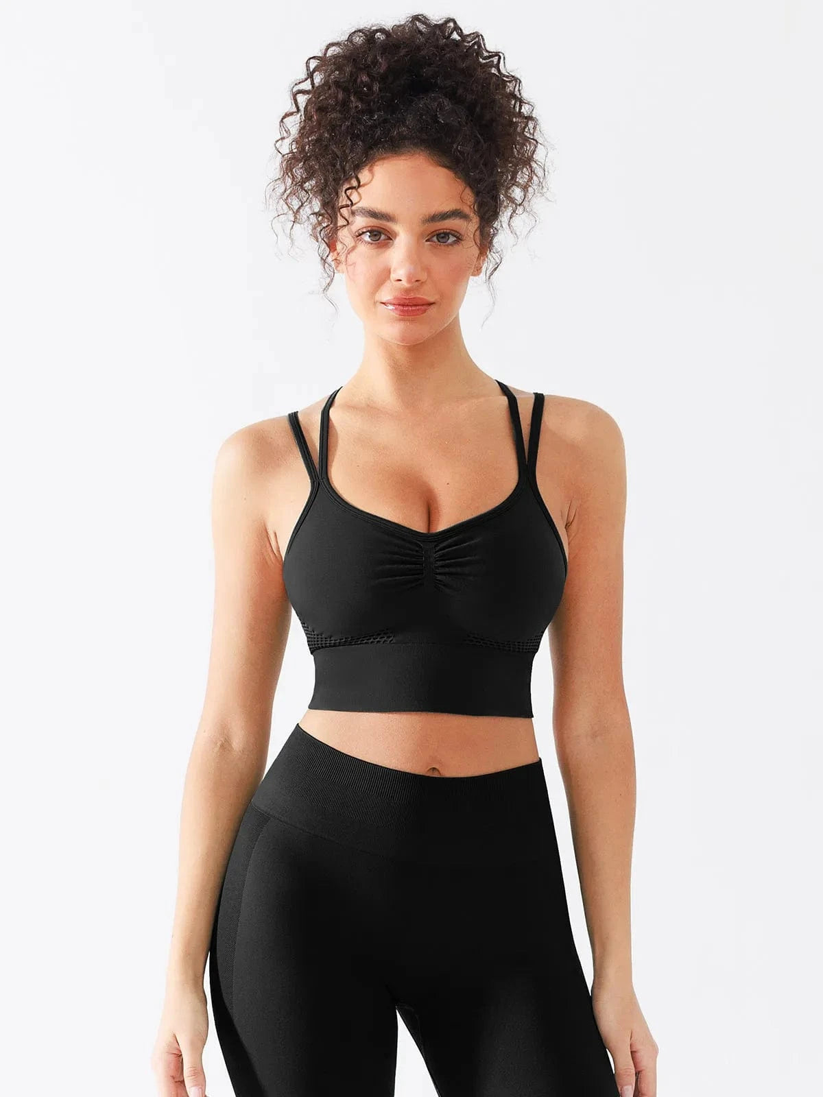 A model wearing a BRXL® Seamless Criss Cross Spaghetti Racerback Sports Bra in