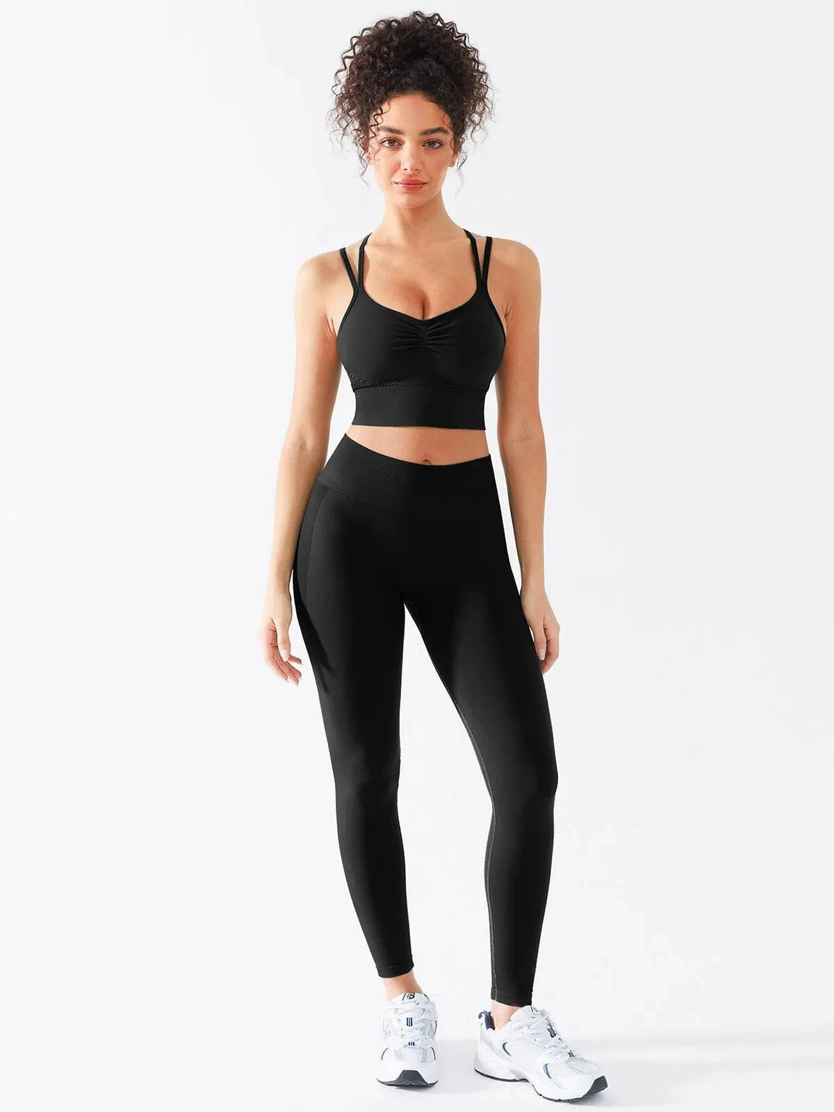 A model wearing a BRXL® Seamless Criss Cross Spaghetti Racerback Sports Bra in