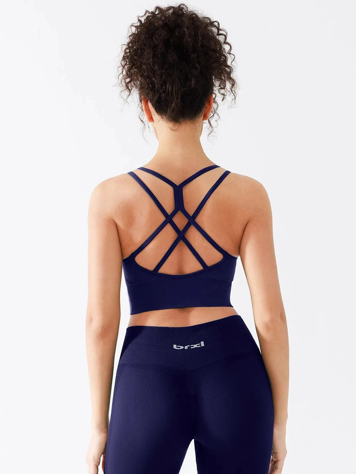 A model wearing a BRXL® Seamless Criss Cross Spaghetti Racerback Sports Bra in