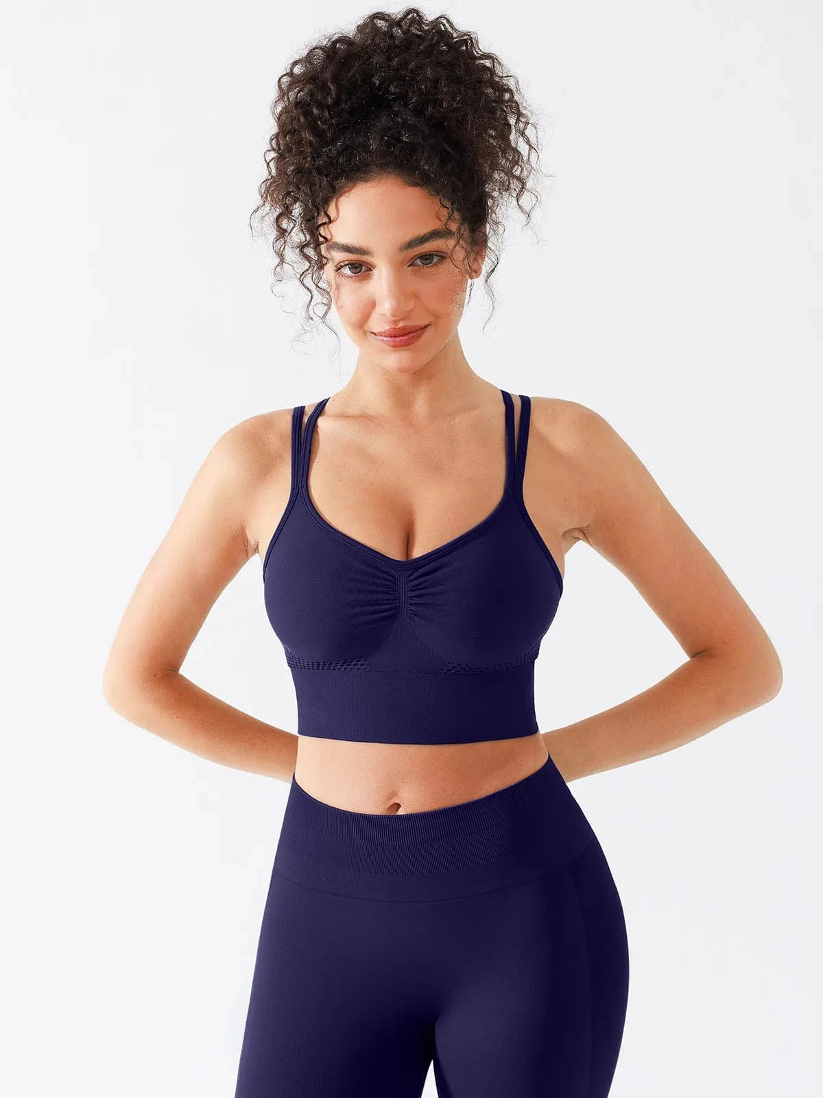 A model wearing a BRXL® Seamless Criss Cross Spaghetti Racerback Sports Bra