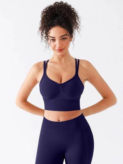 A model wearing a BRXL® Seamless Criss Cross Spaghetti Racerback Sports Bra