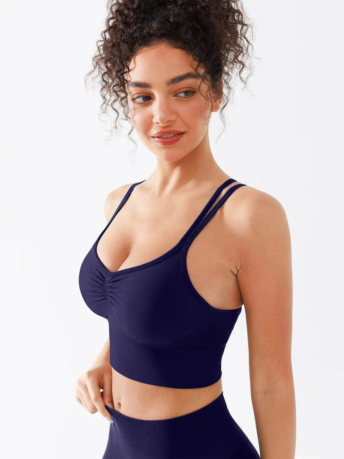 A model wearing a BRXL® Seamless Criss Cross Spaghetti Racerback Sports Bra in