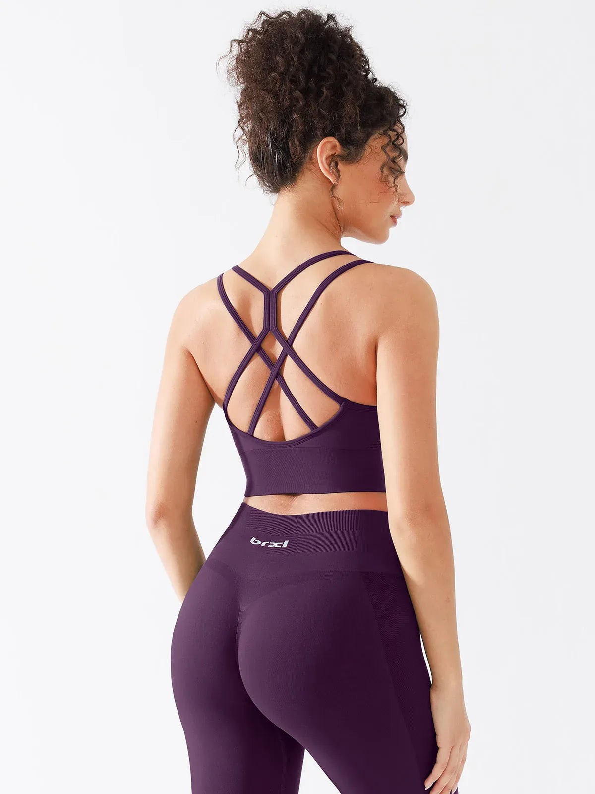 A model wearing a BRXL® B R X L™ Seamless Criss Cross Spaghetti Racerback Sports Bra