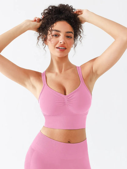 A model wearing a BRXL® B R X L™ Seamless Criss Cross Spaghetti Racerback Sports Bra