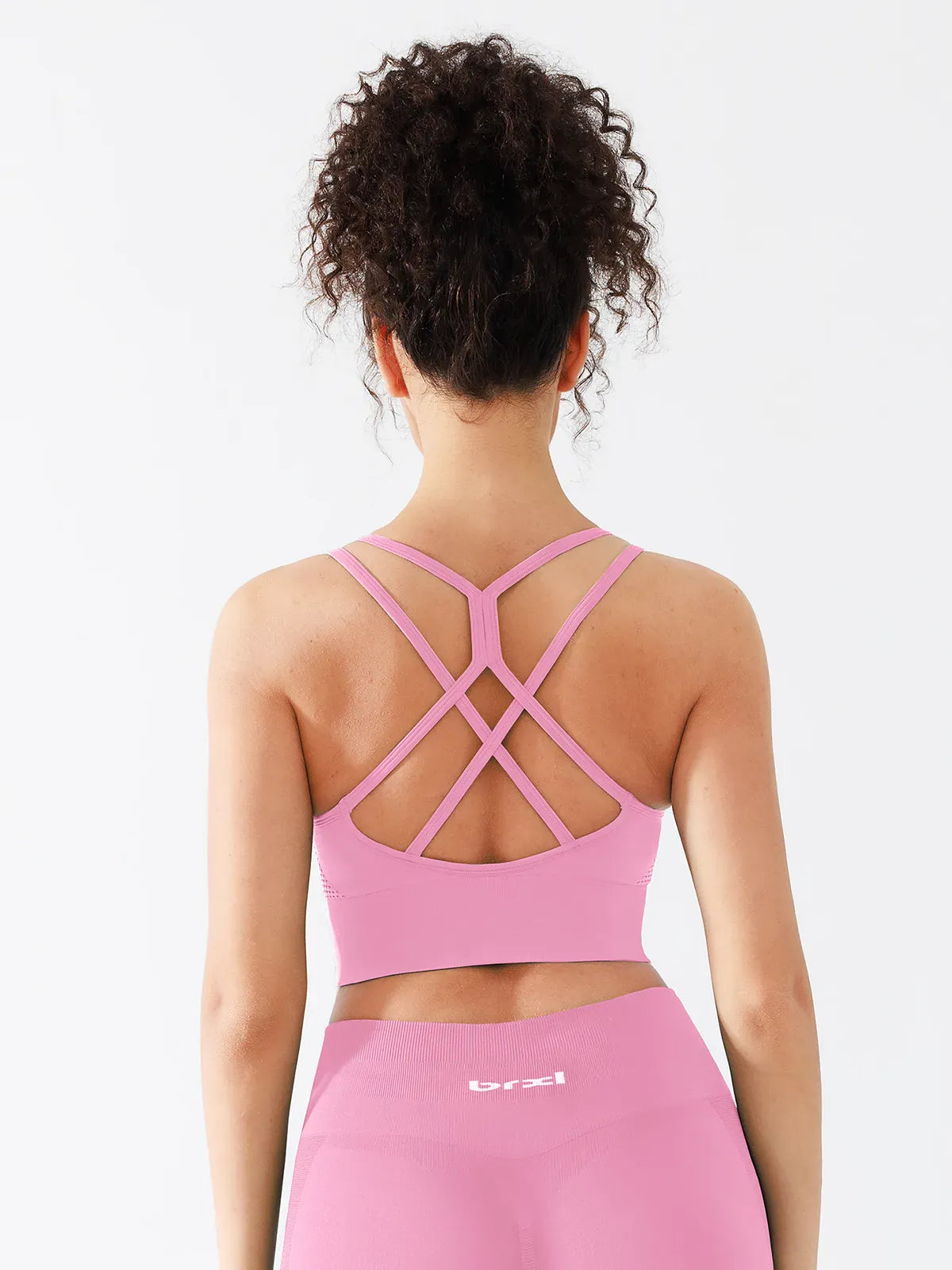 A model wearing a BRXL® B R X L™ Seamless Criss Cross Spaghetti Racerback Sports Bra