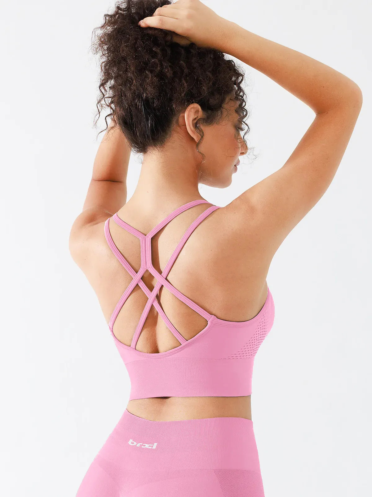 A model wearing a BRXL® B R X L™ Seamless Criss Cross Spaghetti Racerback Sports Bra