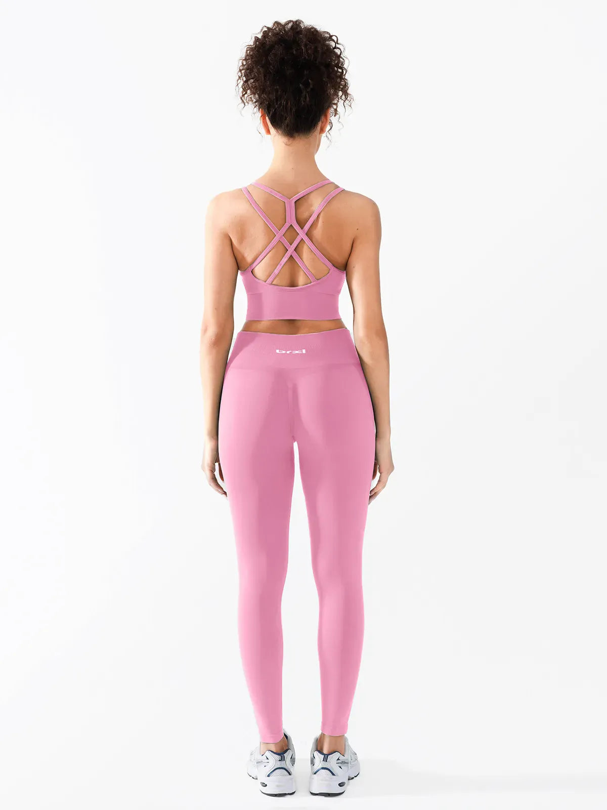 A model wearing a BRXL® B R X L™ Seamless Criss Cross Spaghetti Racerback Sports Bra