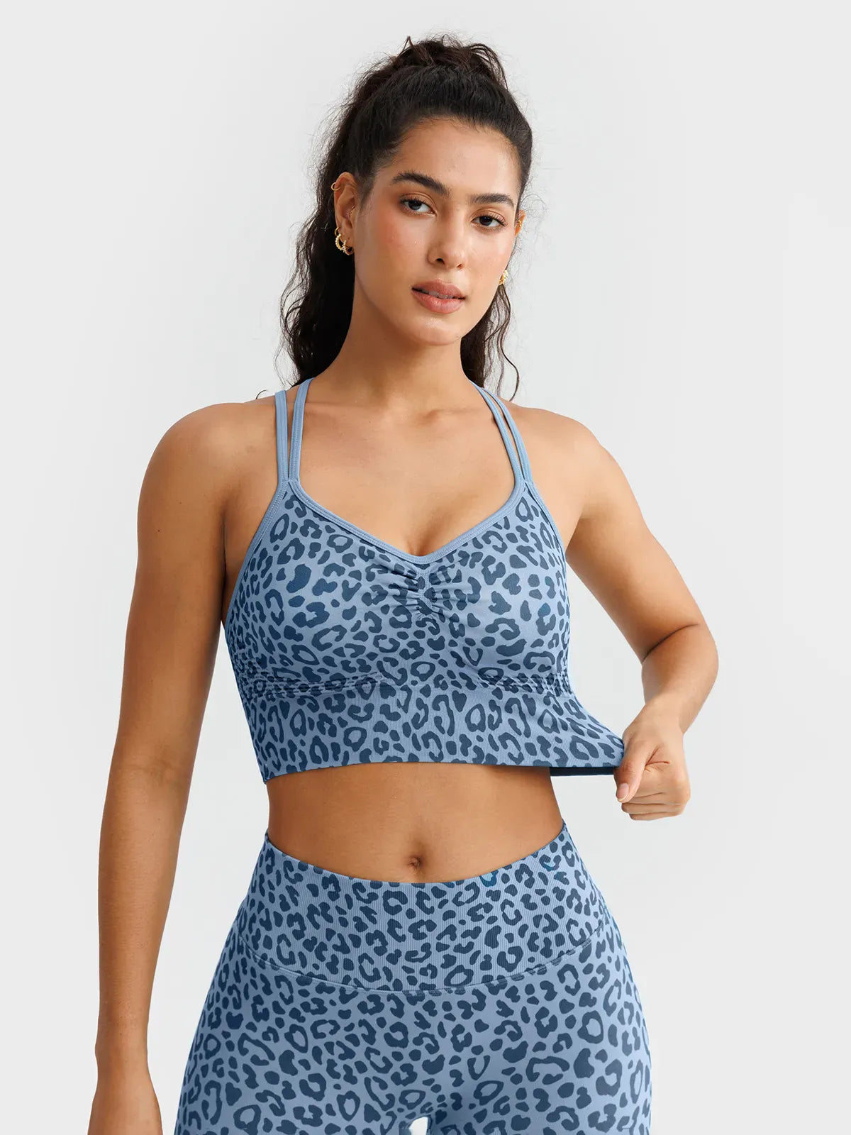 A model wearing a BRXL® B R X L™ Seamless Criss Cross Spaghetti Racerback Sports Bra