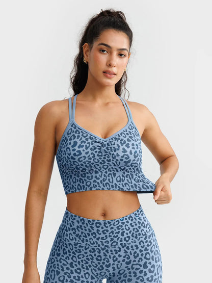 A model wearing a BRXL® B R X L™ Seamless Criss Cross Spaghetti Racerback Sports Bra