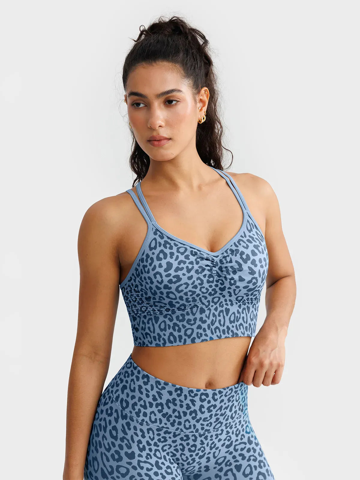 A model wearing a BRXL® B R X L™ Seamless Criss Cross Spaghetti Racerback Sports Bra