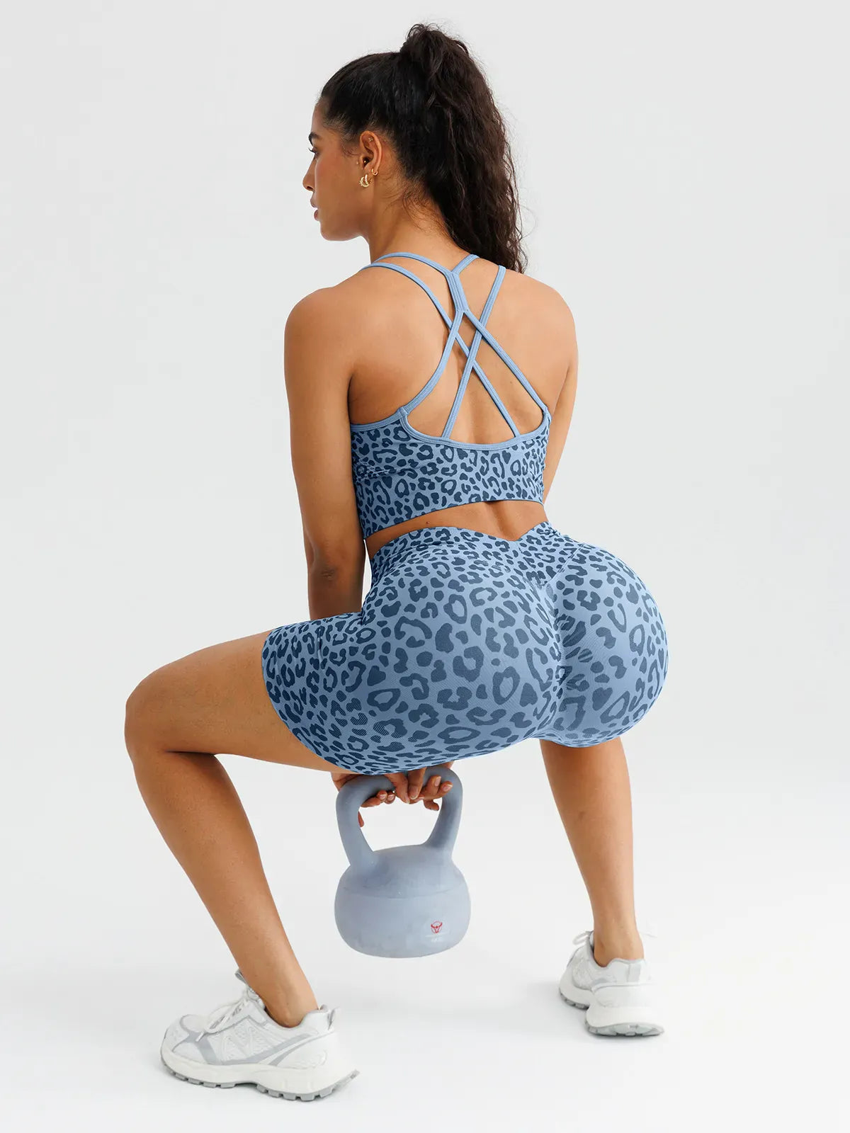 A model wearing a BRXL® B R X L™ Seamless Criss Cross Spaghetti Racerback Sports Bra