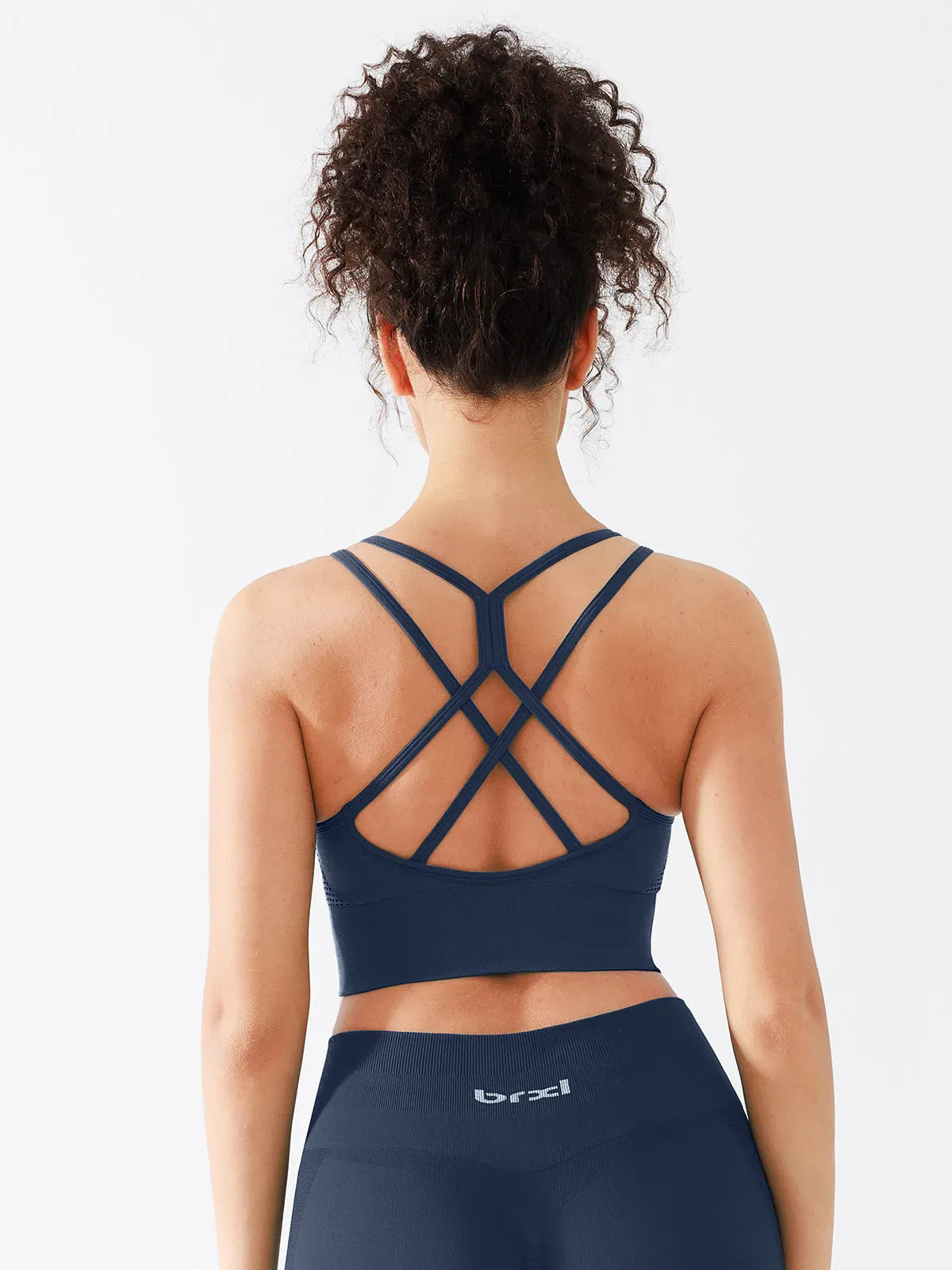 A model wearing a BRXL® B R X L™ Seamless Criss Cross Spaghetti Racerback Sports Bra