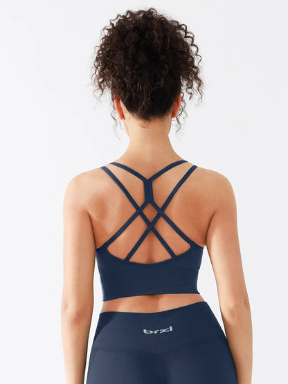 A model wearing a BRXL® B R X L™ Seamless Criss Cross Spaghetti Racerback Sports Bra