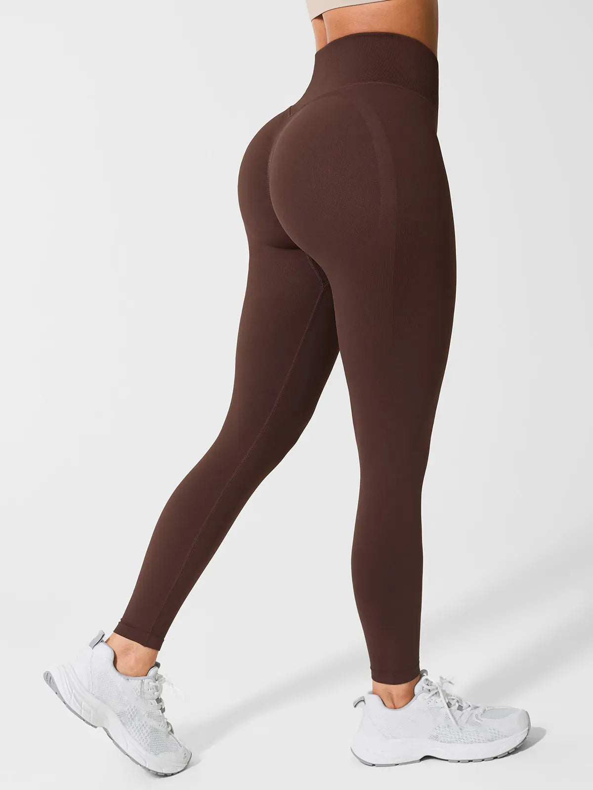 A model wearing a BRXL® Seamless High Waisted Butt-Lifting Leggings in Brown (Glute push-up) / XS