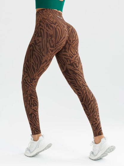 A model wearing a BRXL® B R X L™ Seamless High-Stretch High-Rise Sculpt Leggings 2.0 Brown Zebra / XS